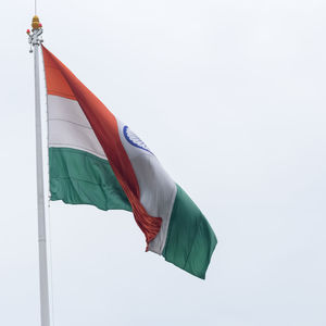 India flag flying high at connaught place with pride in blue sky, india flag fluttering, indian flag