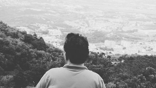 Rear view of man overlooking landscape from sintra mountains