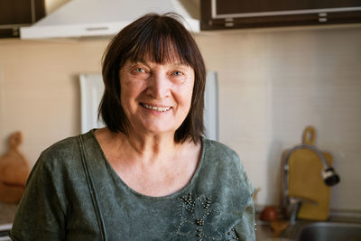 Portrait of young woman sitting at home