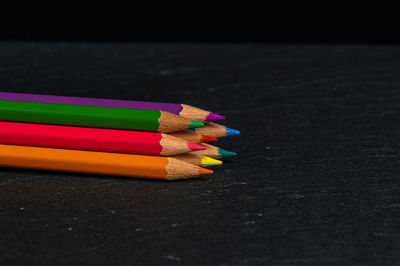 Close-up of multi colored pencils on table