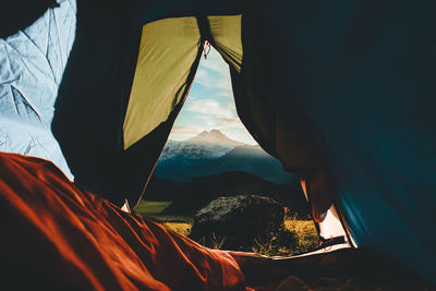 Scenic view of mountains against sky seen through tent