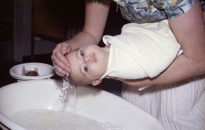 Close-up of boy sitting at home