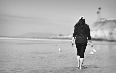 Young woman standing in water