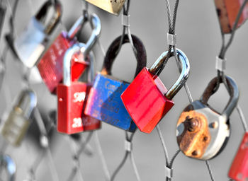 Close-up of love locks hanging on fence