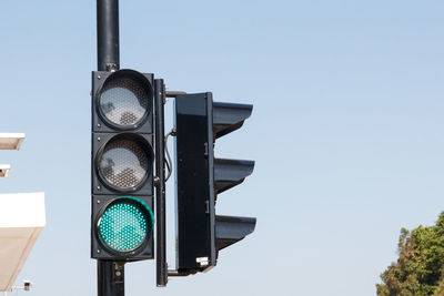 Green traffic light ,isolated on sky background