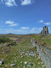 Old ruins on land against sky