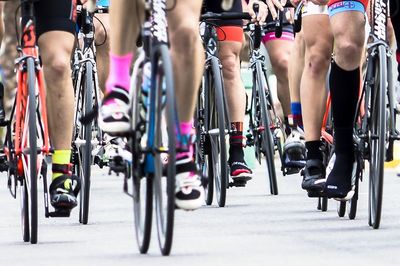 Low section of women riding bicycles in city street