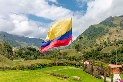 Low angle view of flag against mountain