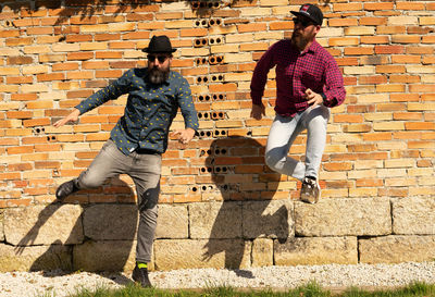 Men with beards jump