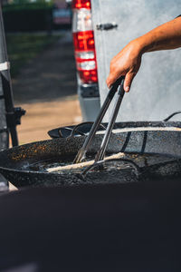 Cropped hand of person washing car