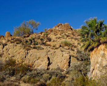 Rock formations in desert against clear blue sky