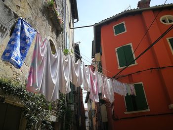 Low angle view of flags hanging on building