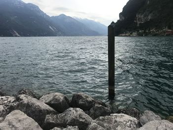 Scenic view of sea and mountains against sky