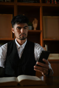Businessman using smart phone at office