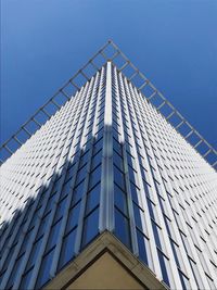 Low angle view of modern building against clear blue sky