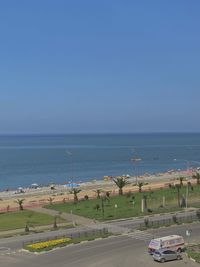 Road by sea against clear sky