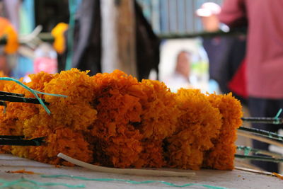 Close-up of orange flowers in pot for sale