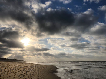 Scenic view of beach against sky during sunset