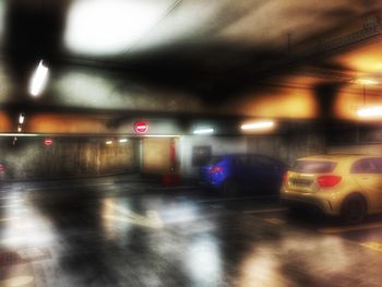 Cars moving on illuminated underground walkway