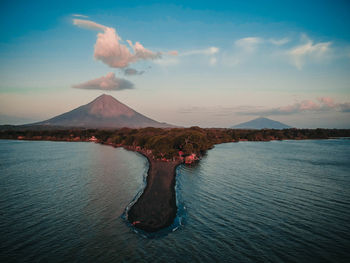 Scenic view of sea against sky and volcano