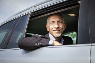 Businessman looking from window while sitting in car