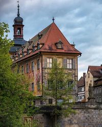 Buildings against cloudy sky