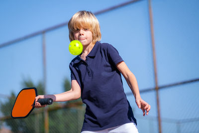 Young woman holding tennis