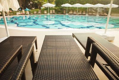 High angle view of lounge chairs by swimming pool