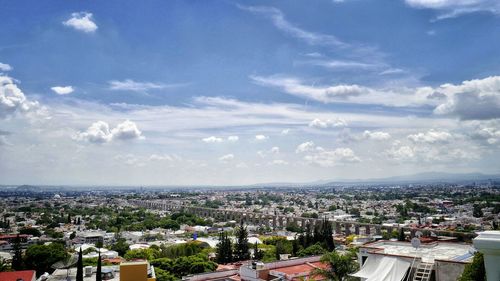 Town against cloudy sky