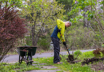 Side view of man working in park