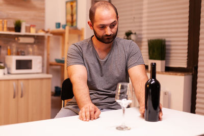 Portrait of young man sitting at home