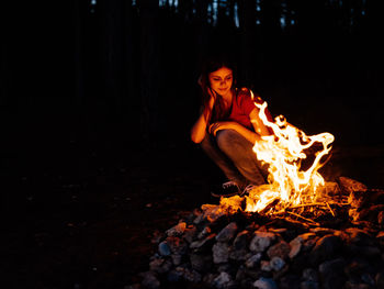 High angle view of woman sitting on bonfire