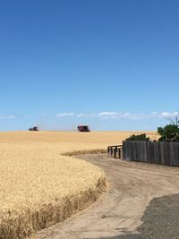 Scenic view of land against blue sky