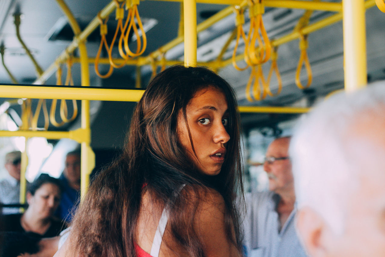 real people, young women, leisure activity, women, young adult, portrait, lifestyles, adult, headshot, people, public transportation, incidental people, focus on foreground, group of people, front view, rail transportation, casual clothing, looking away, transportation, hairstyle, beautiful woman