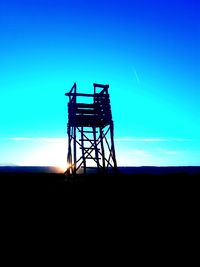 Silhouette landscape against clear blue sky