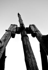 Low angle view of old wooden post against sky
