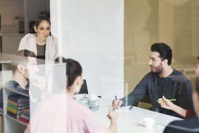 Multi-ethnic business people discussing at table in conference room