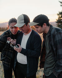 Group of friends reviewing drone footage