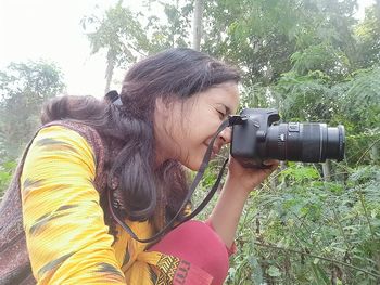 Woman photographing with camera