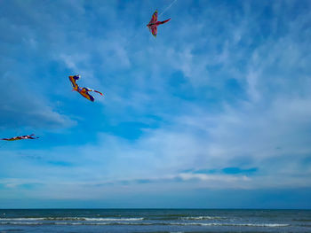 Colorful kites flying in the blue sky at the beach of italy