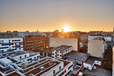 High angle view of buildings in city during sunset