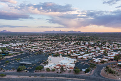 Aerial view of desert hills community with episcopal church in green valley, arizona at sunset 