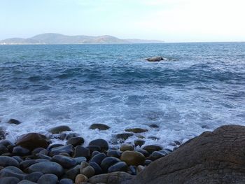 Scenic view of sea against cloudy sky