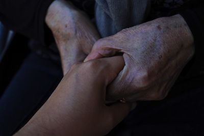 Close-up of hand holding leg