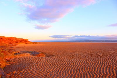 Scenic view of desert against sky during sunset