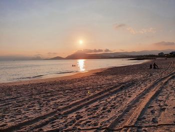 Scenic view of beach against sky during sunset