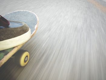 Low section of person skateboarding on road