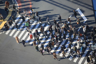 High angle view of people walking on road