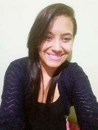 Portrait of a smiling young woman over white background