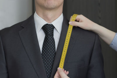 Midsection of a man holding camera